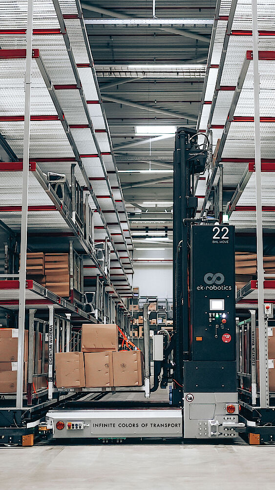 A black four-way stacker is used to store packages in the mobile rack.